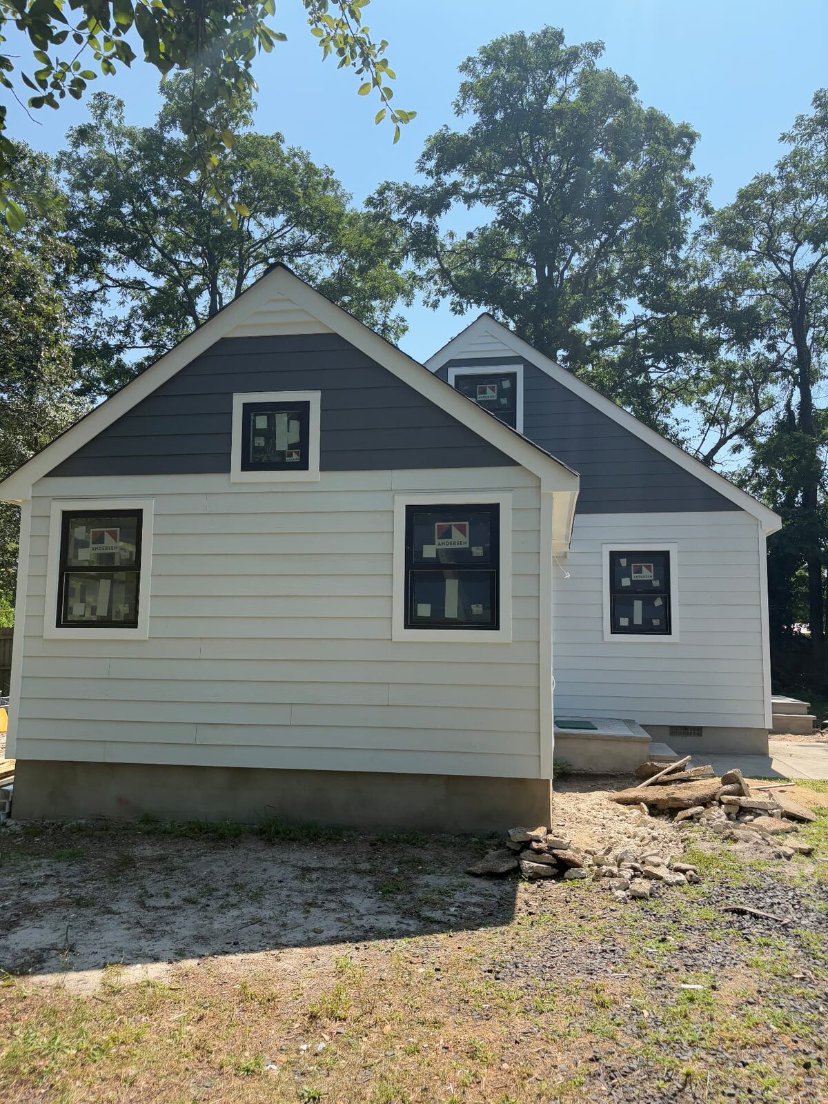 Home exterior with newly installed two-tone siding, trim and windows